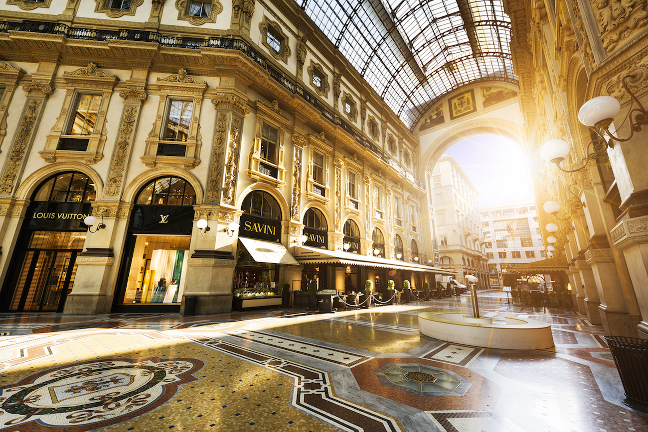 MILAN ITALY - AUGUST 29 2015: Luxury Store in Galleria Vittorio Emanuele II shopping mall in Milan with shoppers and tourists strolling around. Prada is an Italian luxury fashion house founded in 1913